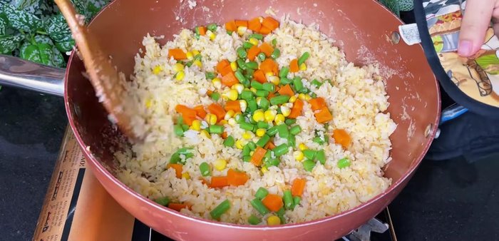 Add blanched vegetables. Stir-fry over high heat until rice is loose.