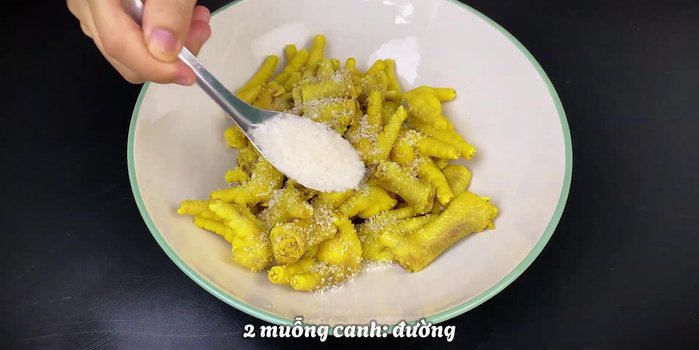 In a bowl, combine drained chicken feet, sugar, salt, lemon juice, and pepper.