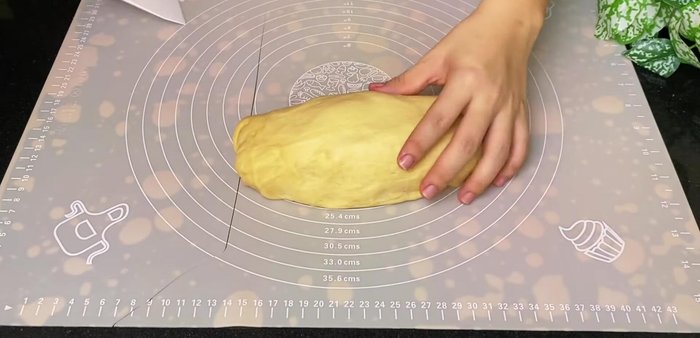 Shape the bread: Divide the risen dough into three equal portions. Roll each portion into a rectangle, spread with some butter, and roll it up tightly. Place in baking molds.