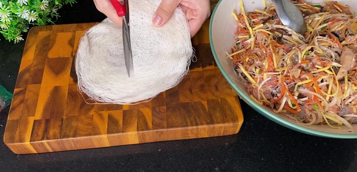 Cut rice paper in half. Place a portion of the filling in the center of the rice paper.