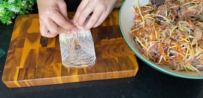 Fold the sides of the rice paper inwards, then roll tightly. Brush with egg white to seal.