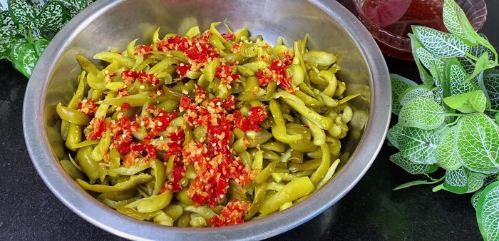 Combine ingredients: In a large bowl, combine the squeezed cucumbers, blended garlic-chili mixture, and cooled fish sauce. Mix well to ensure the cucumbers are evenly coated.