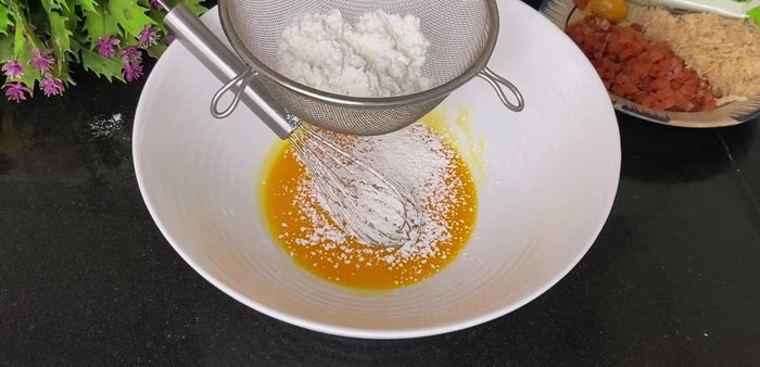 Sift dry ingredients: Sift together cornstarch and flour (number 8) into the yolk mixture. Gently fold until just combined.