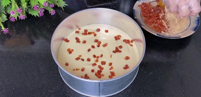 Layer the cake: Pour half of the batter into the prepared pan. Add Lap Xuong, salted egg floss, and seaweed leaves. Pour the remaining batter on top.