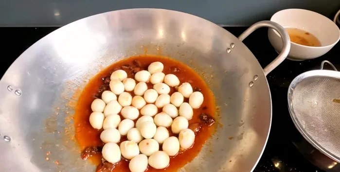 Add the fried quail eggs to the sauce and simmer until the sauce is almost gone, but still slightly wet.