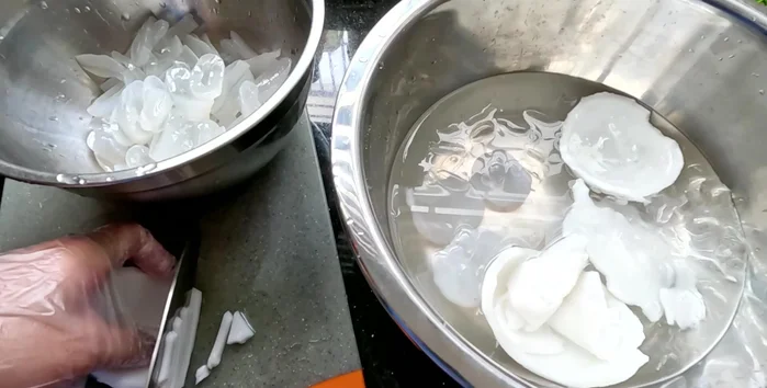 Cut the coconut meat into thin strips; if young, larger pieces are okay.