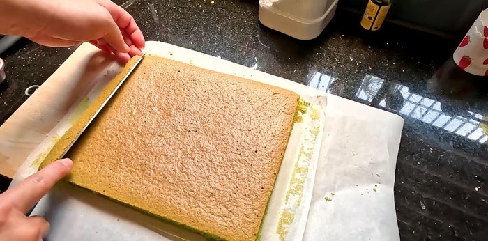 Cut a 45-degree angle at one end of the cake and make several shallow cuts along the cake to aid in rolling. (278.88)