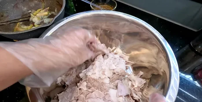Using a blender, mixer, or by hand, thoroughly fluff and rub the pork until it becomes light and airy. This process takes approximately 20-30 minutes.