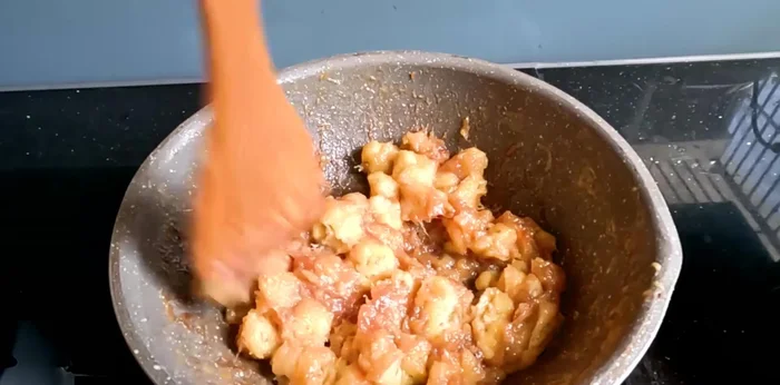Mash the bananas. Once simmered, turn off the heat and mash the bananas until smooth.