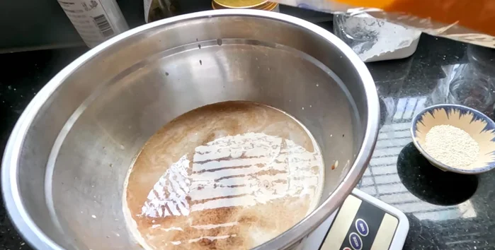 Add sugar (75g-100g depending on desired sweetness) and water (double the amount of soy sauce). Stir until sugar is dissolved.