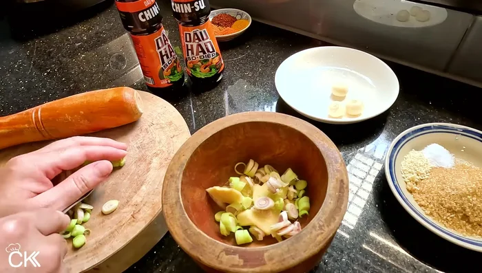 Pound lemongrass, ginger, and garlic until crushed.