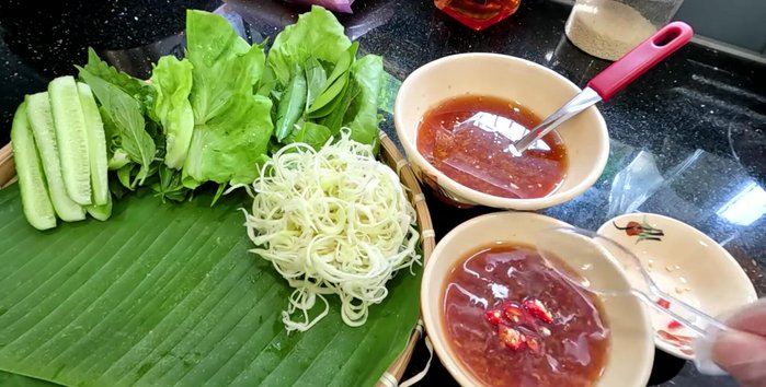 Remove the cooked squid eggs and serve with the ginger fish sauce. Optionally, serve with rice paper and raw vegetables for wrapping.