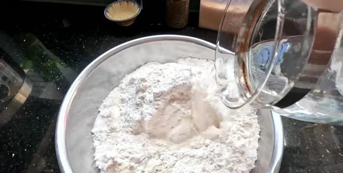Mix 1 kg of wheat flour with 600 ml of water. Knead the dough for 5-10 minutes (60ml water per 100g flour).