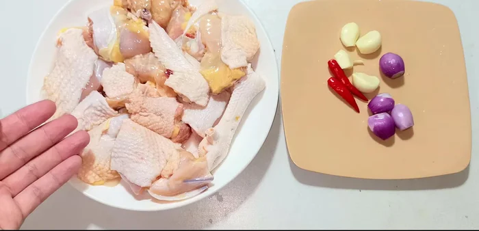 Cut chicken into small pieces, squeeze with lemon and salt, wash, and drain.