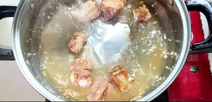 Add 1.3L of water to the pot with the ribs. Bring to a boil. Skim off any foam.