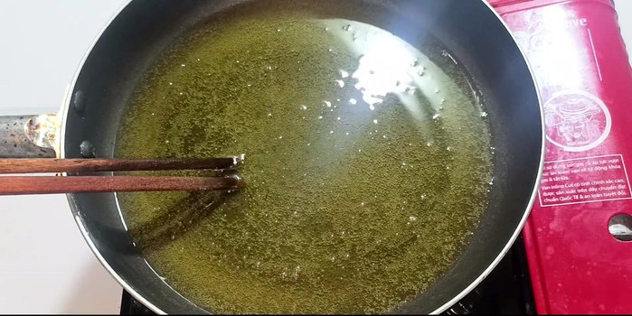 Heat cooking oil in a frying pan over medium-low heat.