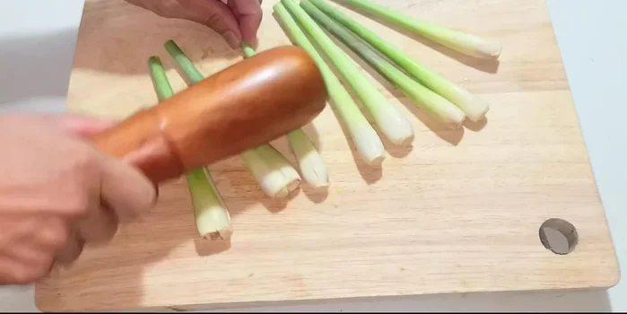 Pound the top of seven lemongrass stalks.