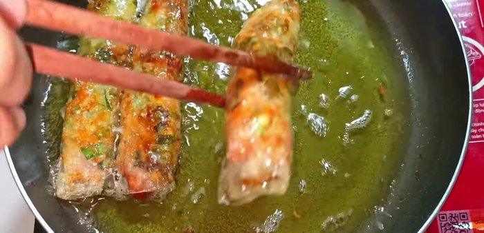 Remove the fried rice paper rolls and place them on a plate lined with paper towels to absorb excess oil.