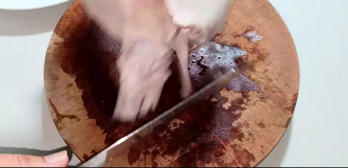 Cut and roll the pig ears: Cut the pig ears, removing some meaty parts to make rolling easier. Roll tightly, securing with string. (132.2)