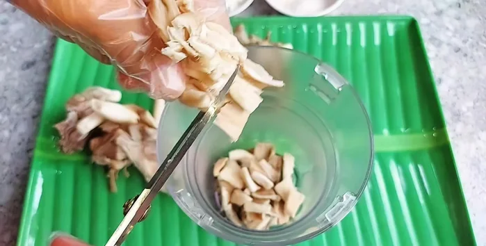 Cut the squeezed mushrooms into small pieces for easier blending. Blend the mushrooms in a blender.