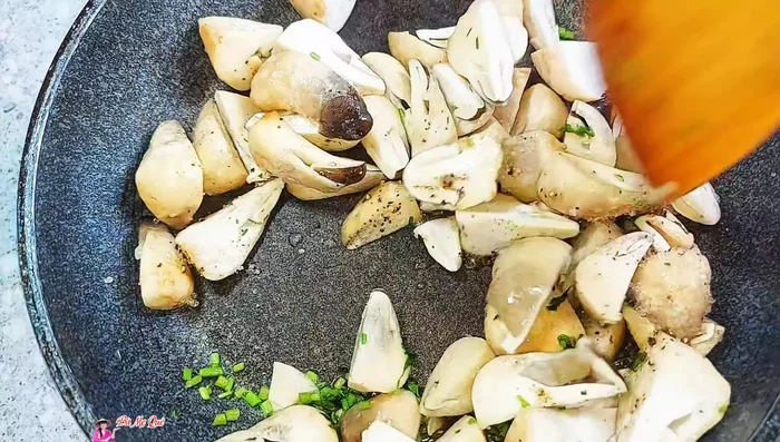 Stir-fry the mushrooms until they absorb the spices.