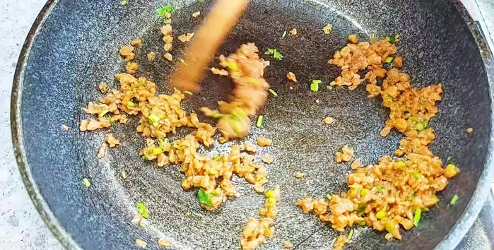 Add ground pepper and cilantro to the minced meat.