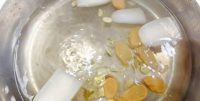 Prepare the soup: Cook coriander stalks, pickled radish, squash, and white radish for 30 minutes. Season to taste.
