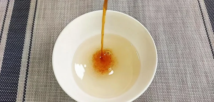 Prepare the dressing by mixing sugar, vinegar, and vegetarian fish sauce until the sugar dissolves.