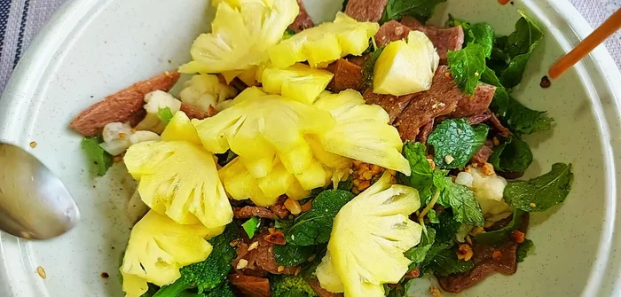 Finally, add the pineapple pieces and roasted peanuts. Gently toss to combine.