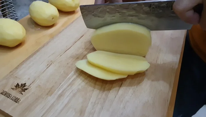 Boil the sliced potatoes for 2-3 minutes to partially cook them.