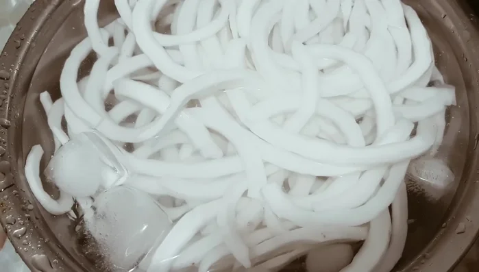 Soak the blanched coconut in ice water for about an hour to remove excess oil.