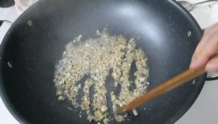 Sauté onions and garlic until fragrant. Add the marinated duck and stir-fry until the flavors combine.