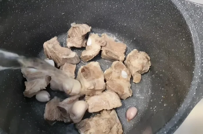 Stew the ribs with 2 shallots and 2 liters of water for 30 minutes.