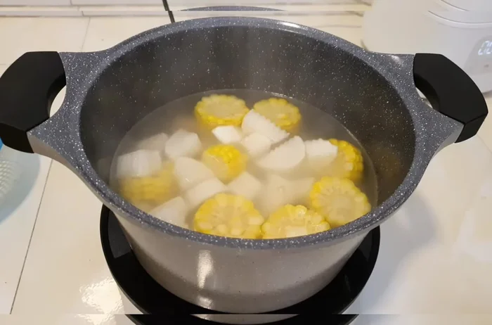 After the corn has cooked, add the radish and carrots. Cook for about 5 minutes until tender.