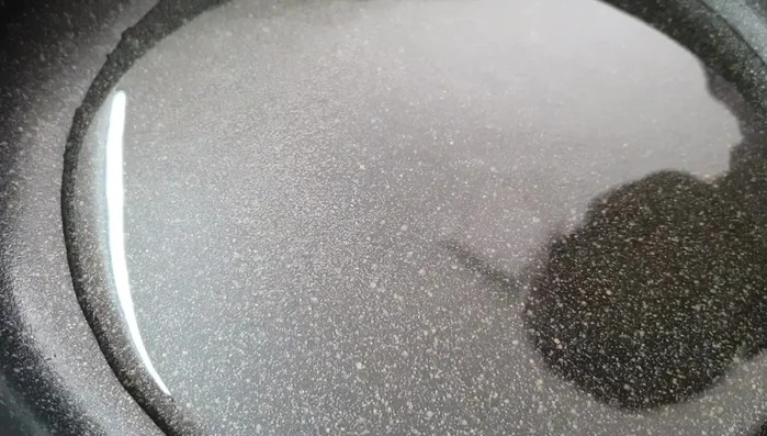 Heat cooking oil in a frying pan until hot.