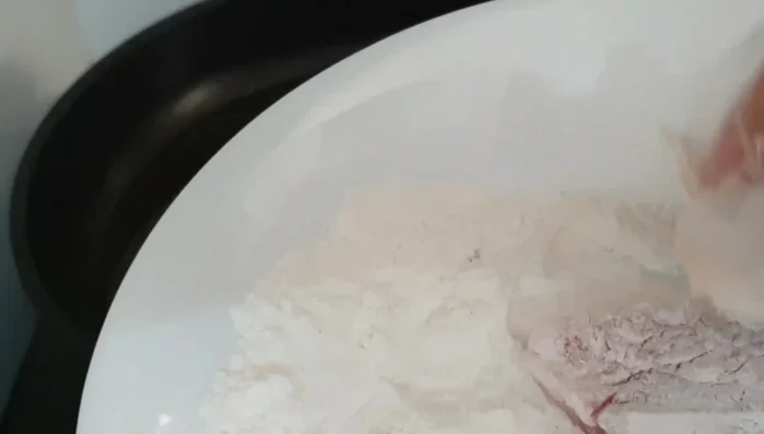 Coat each fish piece with crispy fried flour to ensure even coverage before frying.