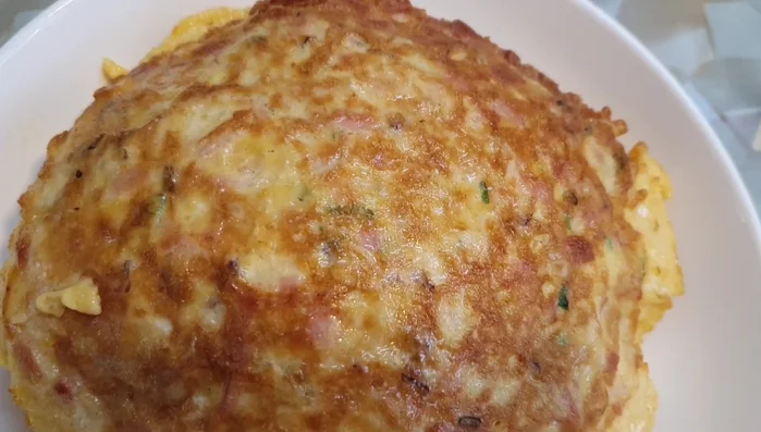 Crack the eggs into the pan.