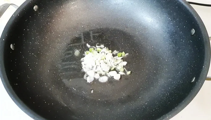 Add carrots and kohlrabi to the pan. Stir-fry.