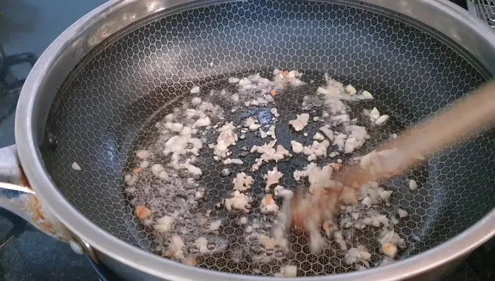 Add soaked shiitake mushrooms and stir-fry.