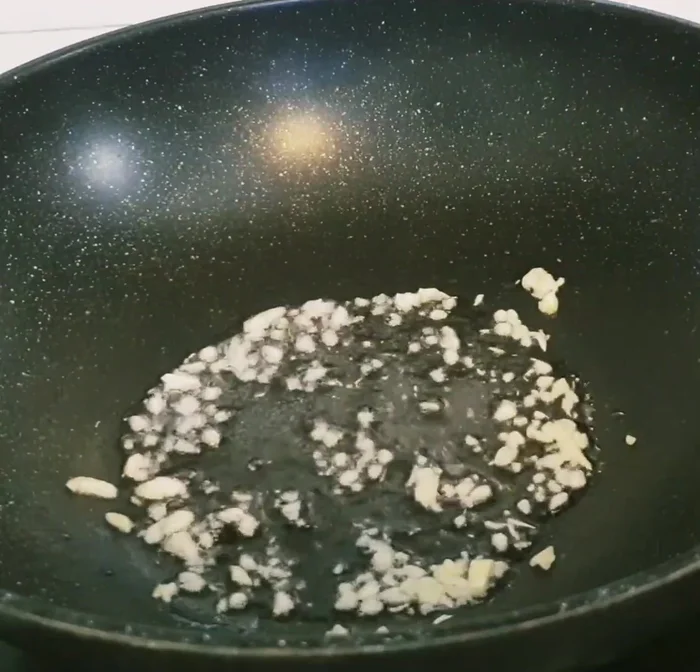 Add the marinated beef to the pan and stir-fry until cooked. Remove the beef from the pan.