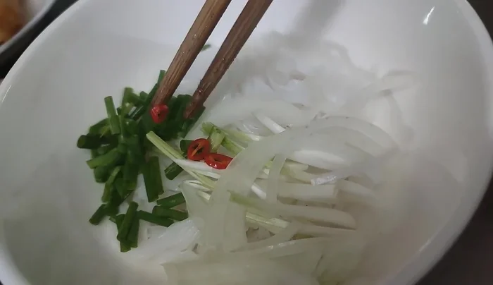 Add chili slices to adult bowls (optional).