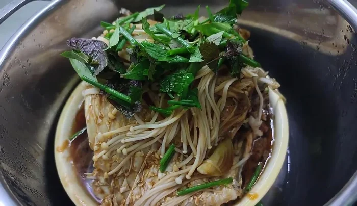 Add green onions, perilla, and Vietnamese coriander. Steam for 5 more minutes.