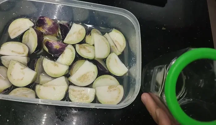 Salt the eggplant: Pack the drained eggplant into clean jars and pour the cooled brine over it.