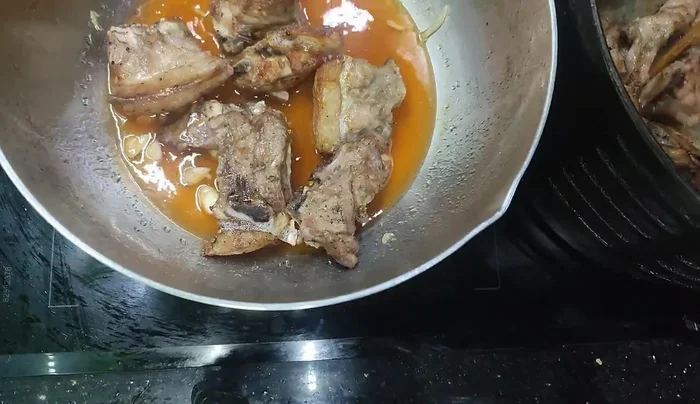 Add the fried ribs to the pan and stir until the sauce thickens.