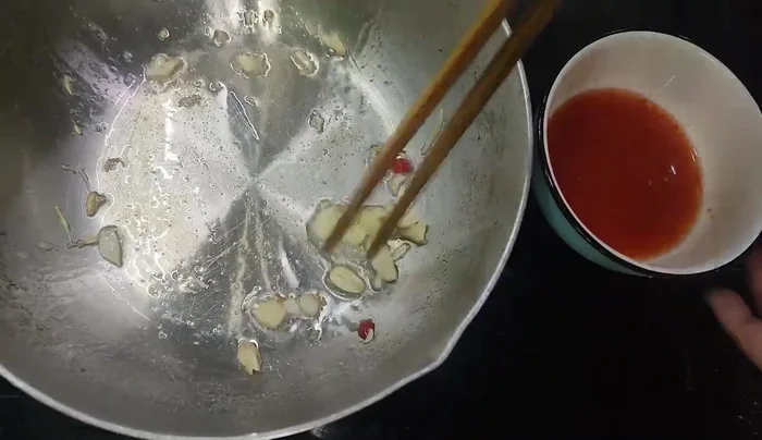 Add the sweet and sour sauce and fish sauce to the pan.
