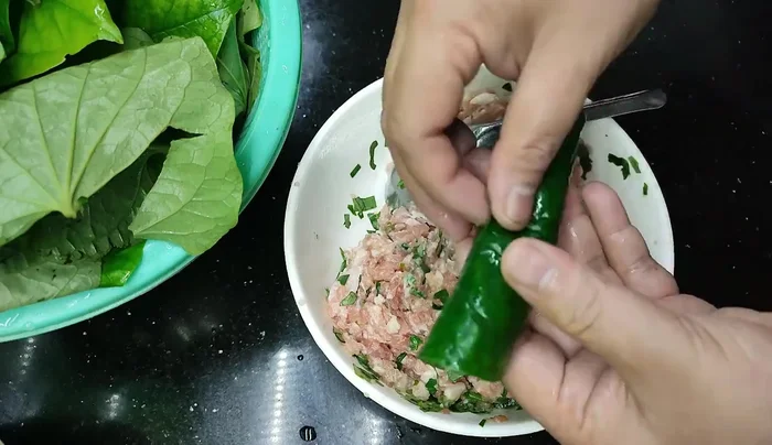Cook the wrapped rolls in a pan over medium heat, keeping them close together to prevent spreading. Ensure both the outside and inside are cooked through without burning the leaves.