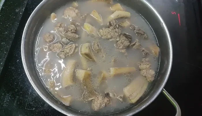 Season the soup to taste. Simmer until the bananas are soft and the bones are tender, about half an hour.