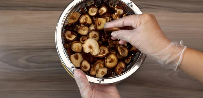 Slice shiitake mushrooms thinly. The thinner, the faster they will roast.
