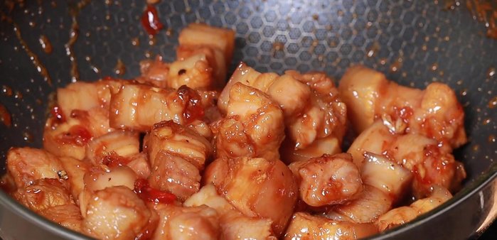 Add 2 cups of boiling water, reduce heat to low, and simmer until the sauce reduces and the meat is tender.
