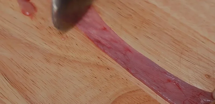 Clean the intestines until they are white and clear. This process ensures a cleaner and better tasting end product. The thorough cleaning is crucial.